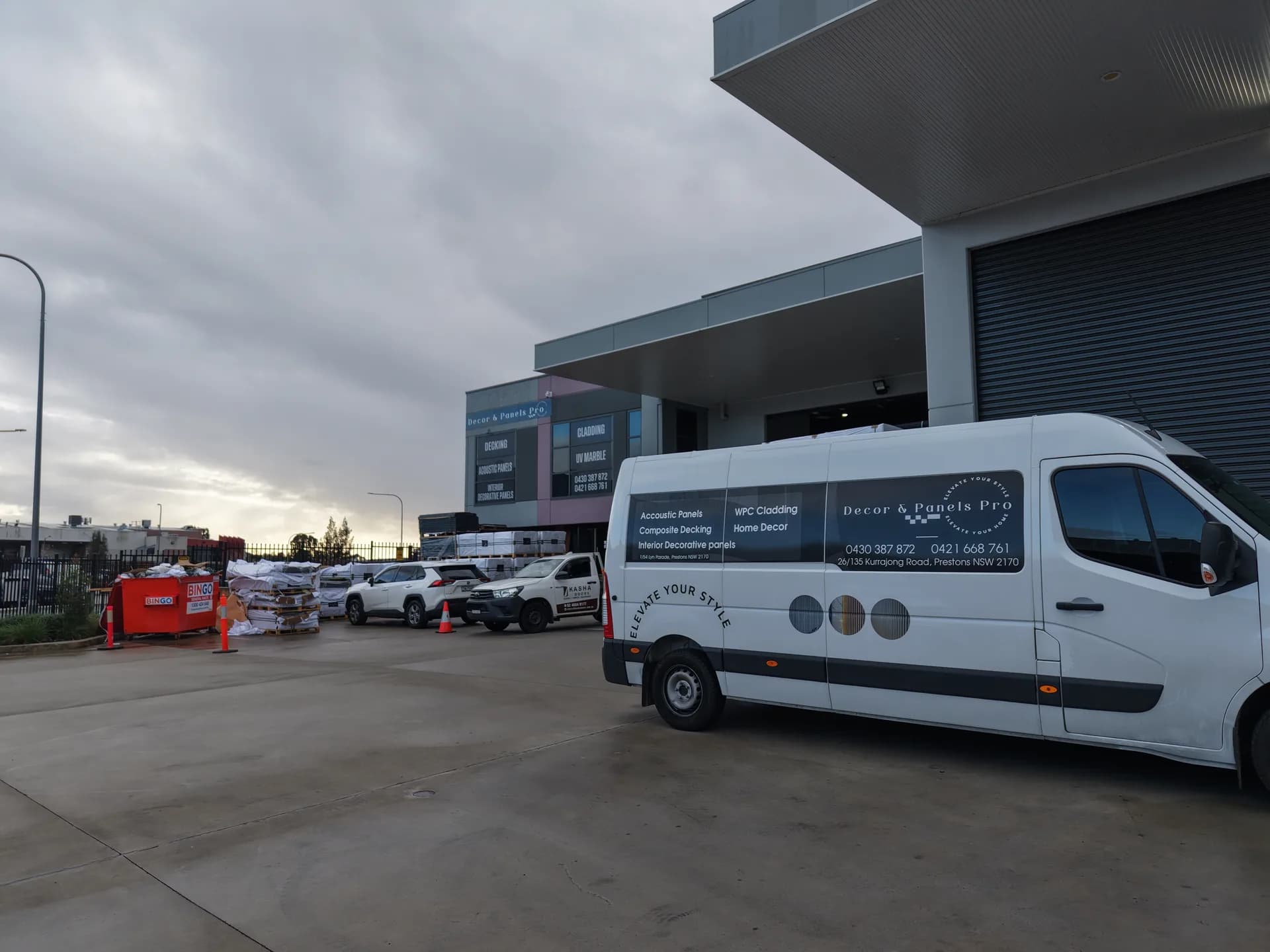 Warehouse entry with Decor & Panels Pro signage and delivery van